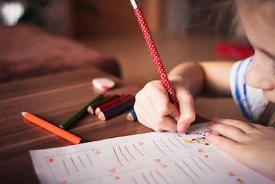 child drawing in classroom